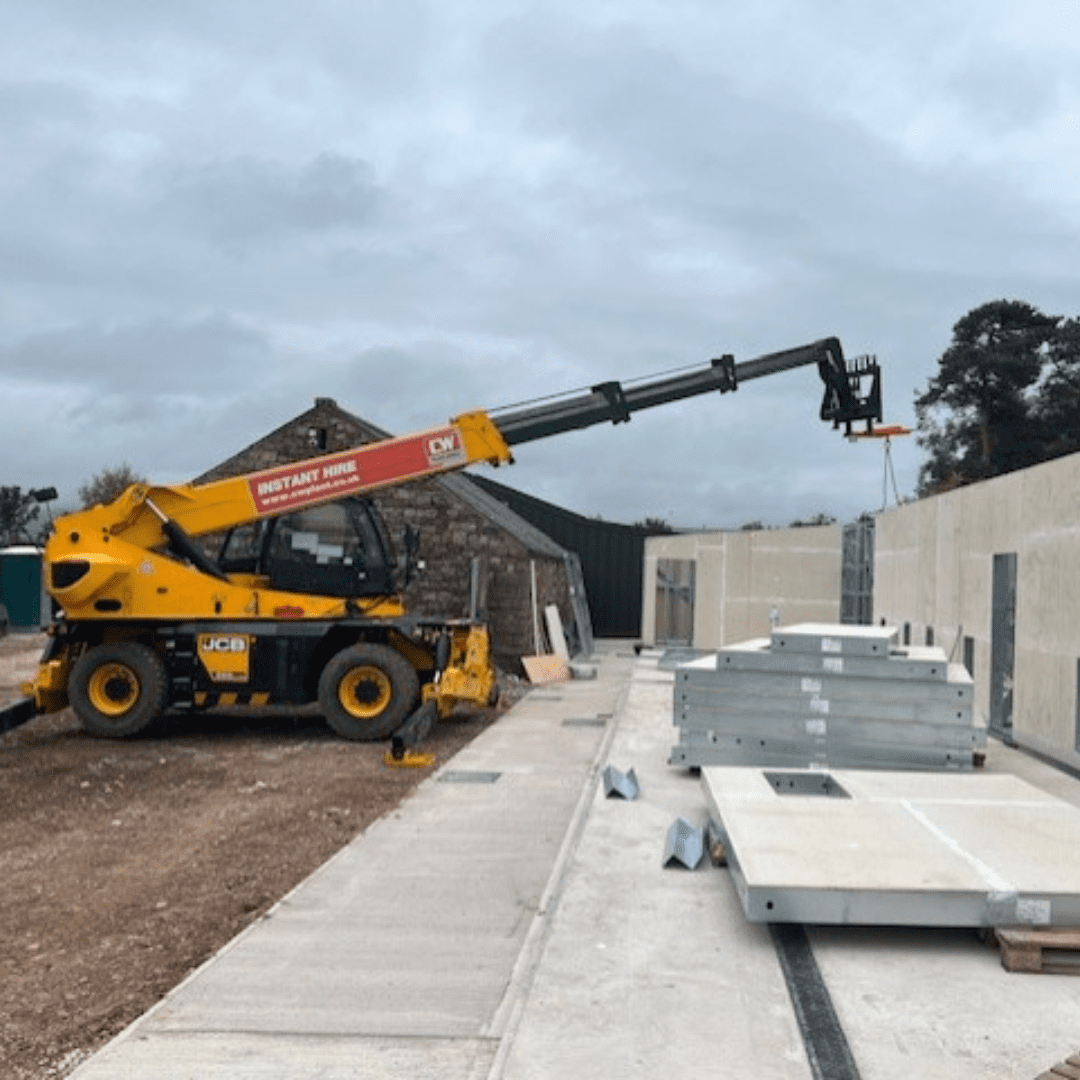 Yellow construction truck at a building refurbishment.