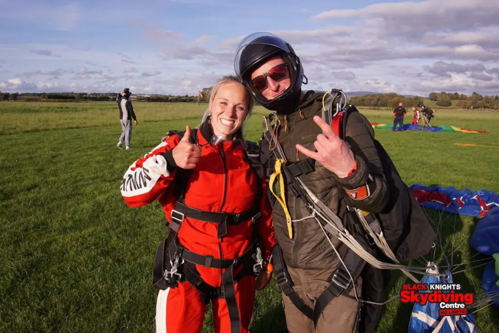 A Pets Foundation team member and a skydiving instructor smiling for the camera.