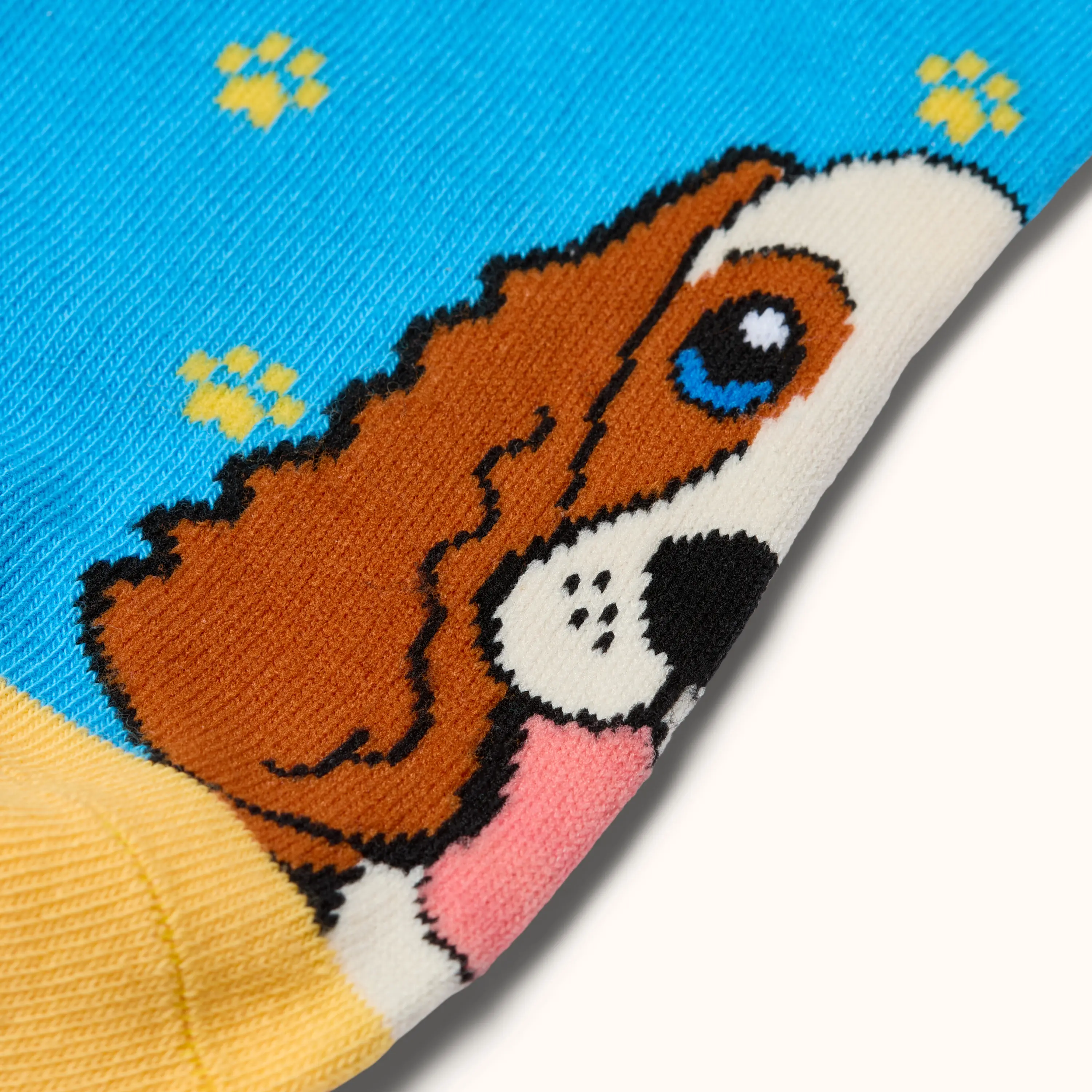 Close-up of the dog design and yellow paw print pattern on Blue Cross Summer Appeal Dog Ankle Socks.