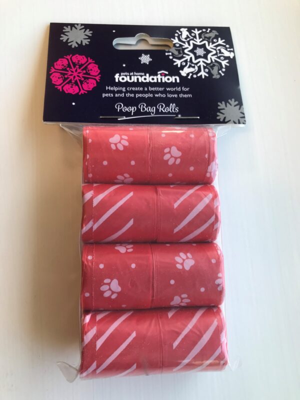 4 pack of red poop bag rolls with white paw print and stripe patterns