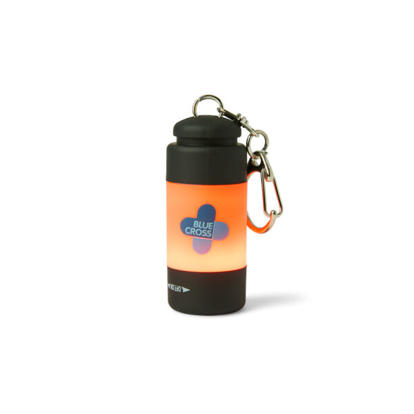 Blue Cross Keyring Torch with a cylindrical design, featuring a black top and bottom, an orange middle section with the Blue Cross logo, and a metal keyring clip attached to the top.